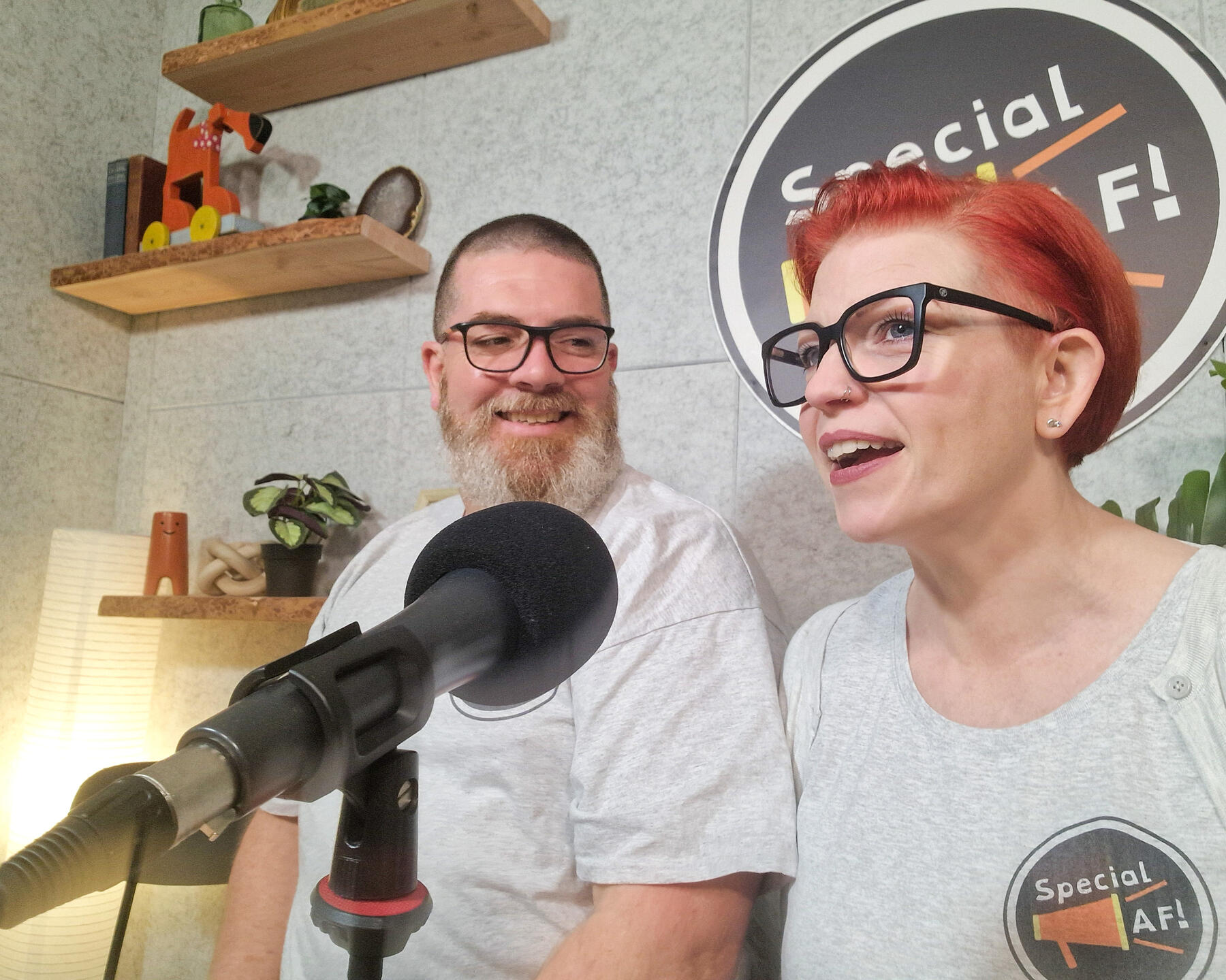 Special AF! podcast An image of a bearded man and a red-haired woman smiling sitting at a podcast desk